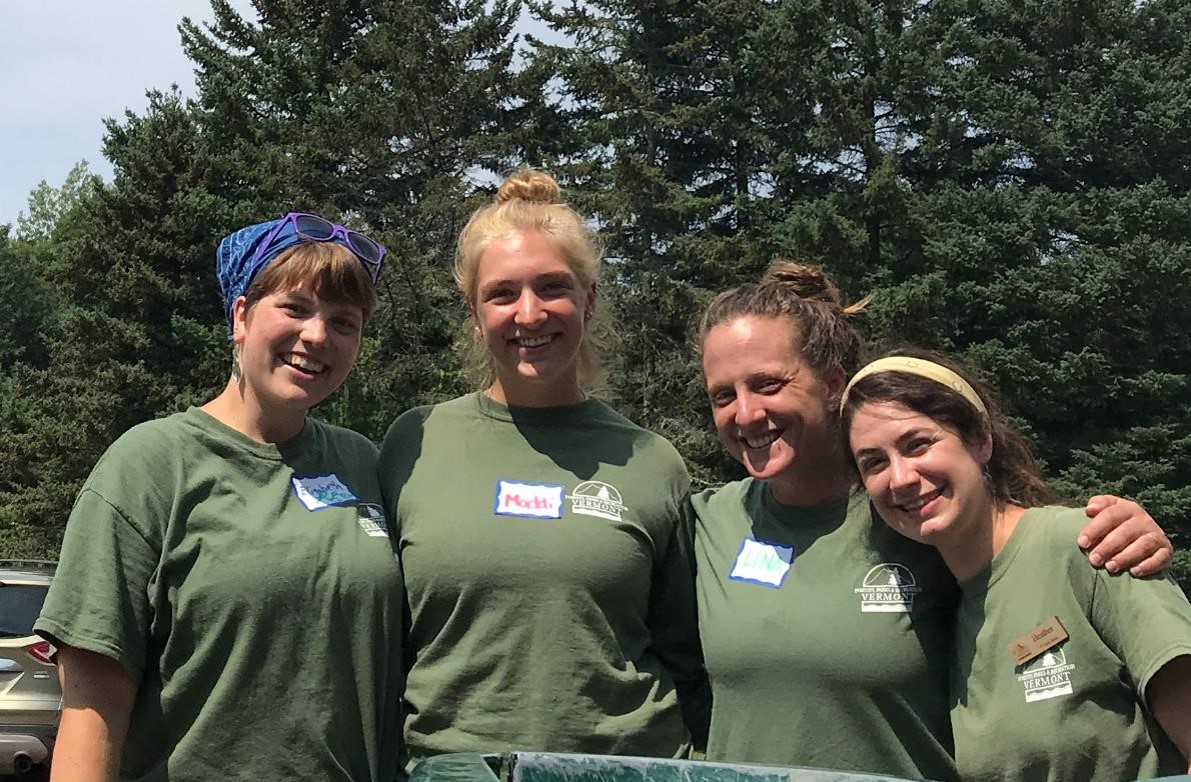 Habitat Restoration crew posing in front of a work site, smiling