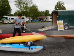 A public access greeter performs a watercraft decontamination.